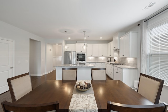 dining room with baseboards, dark wood-type flooring, visible vents, and recessed lighting