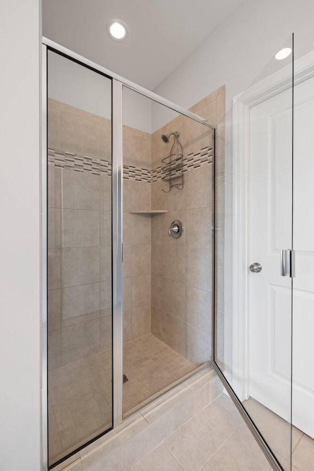 full bath featuring a stall shower, tile patterned flooring, and recessed lighting