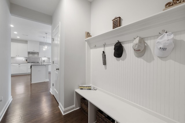 mudroom featuring baseboards, dark wood finished floors, and recessed lighting