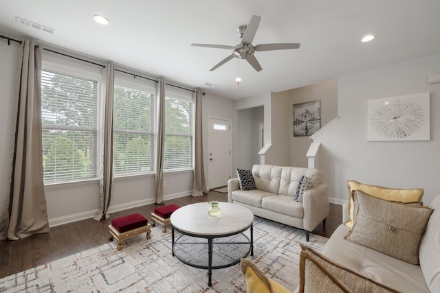 living area with recessed lighting, visible vents, ceiling fan, wood finished floors, and baseboards