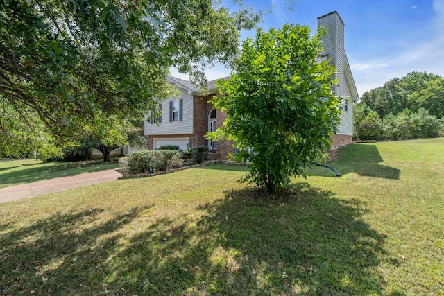 view of yard with driveway and a garage