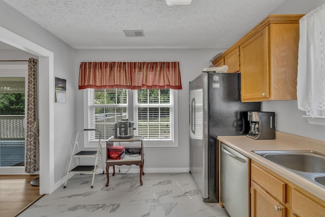 kitchen with visible vents, baseboards, marble finish floor, stainless steel dishwasher, and light countertops