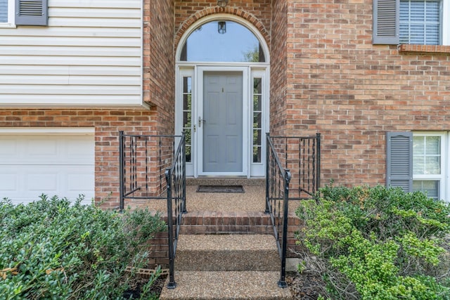 property entrance featuring brick siding