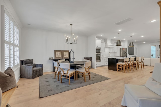 dining space featuring light wood-style floors, visible vents, and recessed lighting