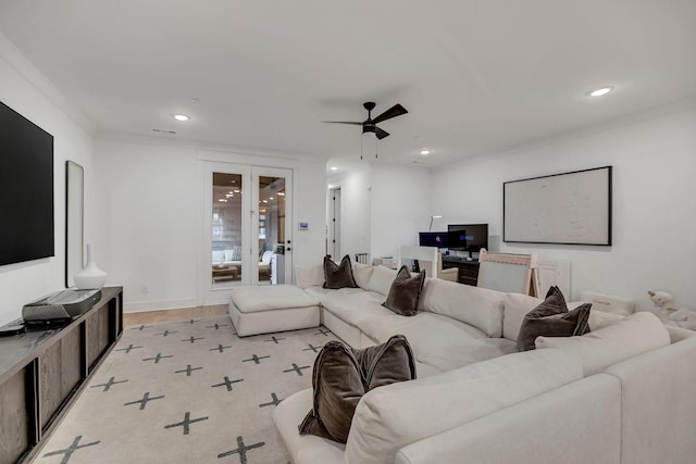 living area featuring recessed lighting, a ceiling fan, ornamental molding, french doors, and light wood-type flooring