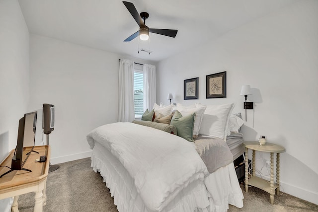 carpeted bedroom featuring ceiling fan, visible vents, and baseboards