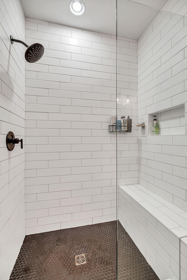 bathroom with tiled shower