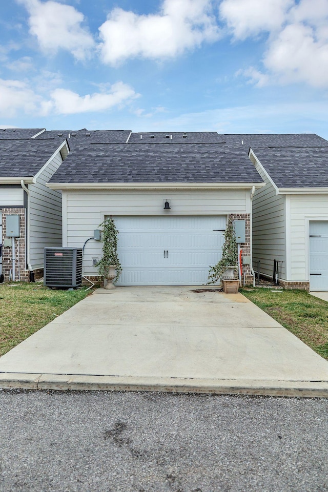 garage with driveway and central AC