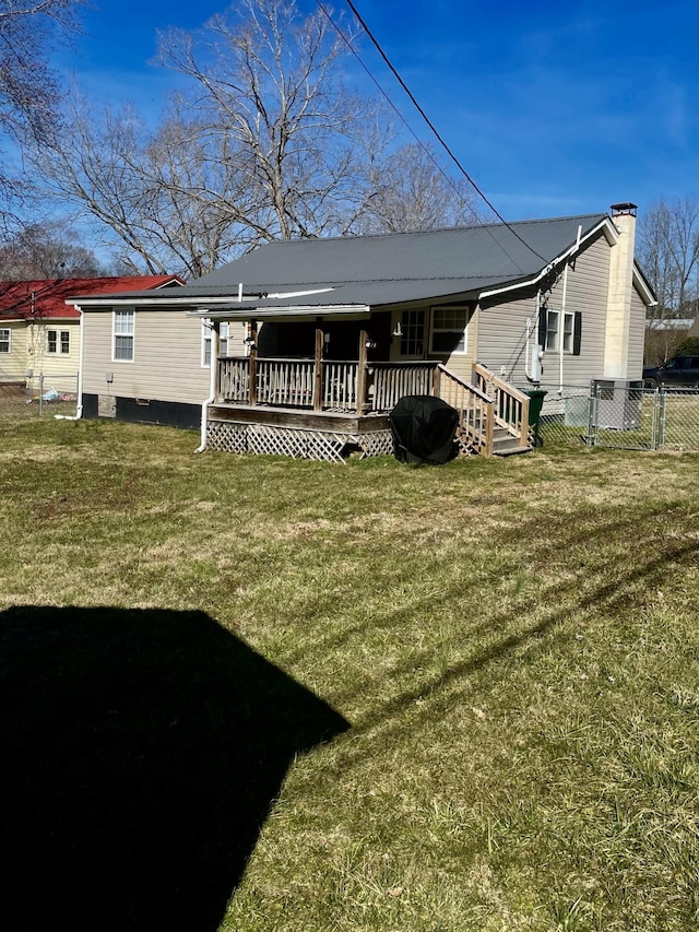 back of house featuring a yard and fence