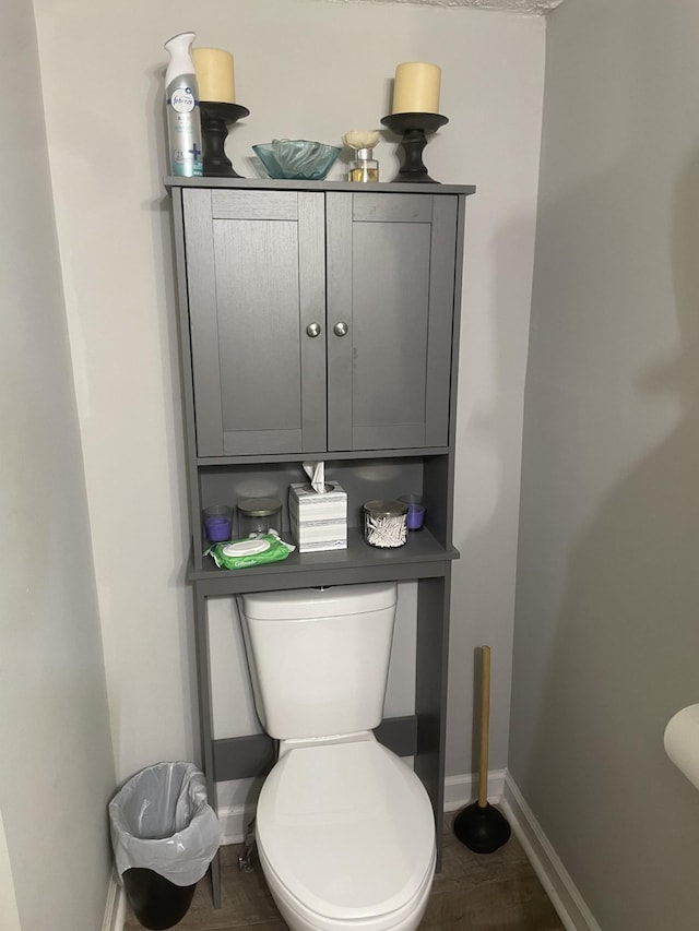 bathroom with toilet and baseboards