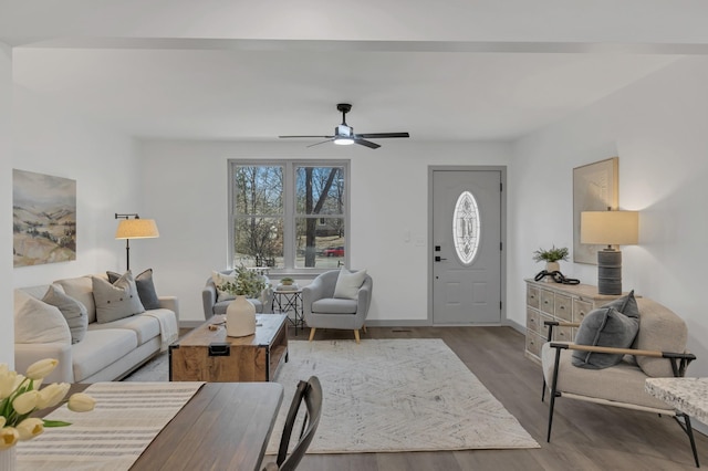 living room with ceiling fan, wood finished floors, and baseboards