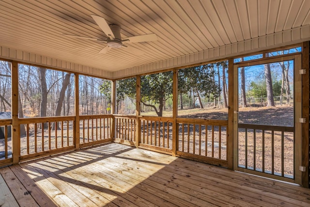 unfurnished sunroom featuring a ceiling fan