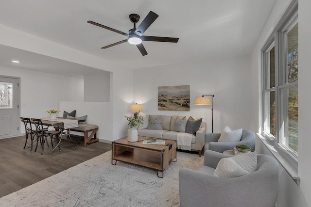 living room featuring a ceiling fan and wood finished floors