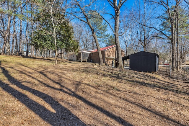 view of yard featuring an outbuilding and a shed