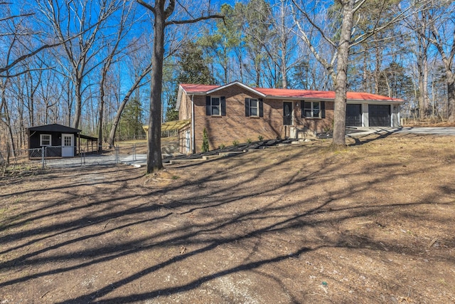 view of front of property with an attached garage, driveway, fence, and brick siding