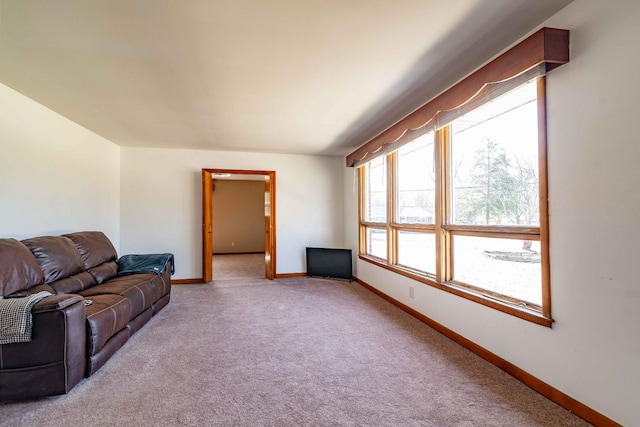 living room featuring carpet and baseboards