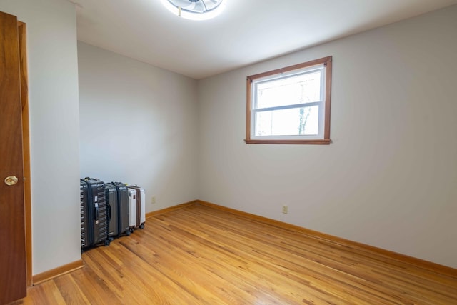 empty room with light wood-style flooring and baseboards