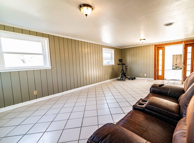 living area with light tile patterned flooring, visible vents, and baseboards