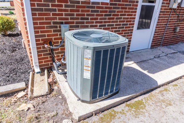 exterior details with brick siding and central air condition unit