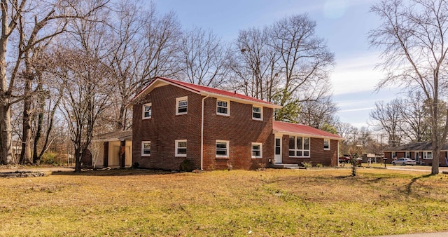 view of side of home with a lawn