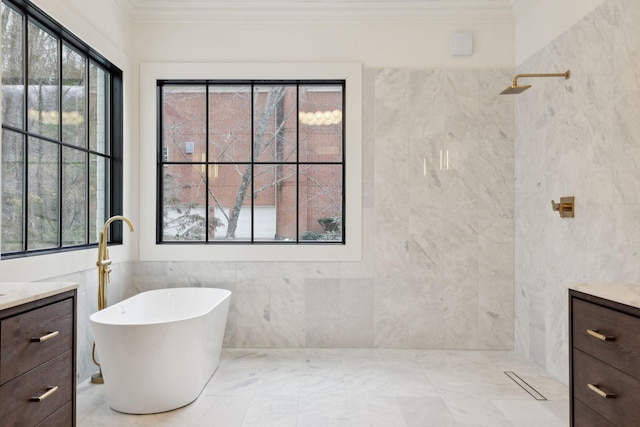 full bathroom featuring a soaking tub, crown molding, and vanity