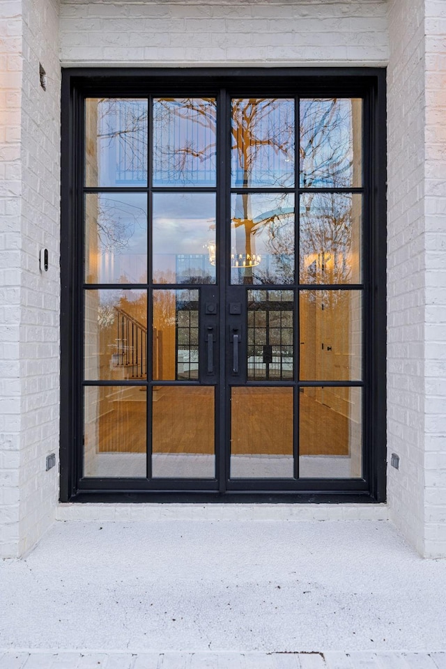 property entrance featuring brick siding