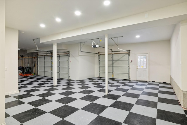 garage with recessed lighting and a garage door opener