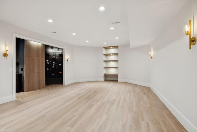 interior space with light wood-type flooring, baseboards, visible vents, and recessed lighting