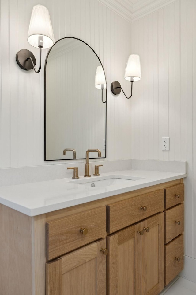 bathroom with crown molding and vanity