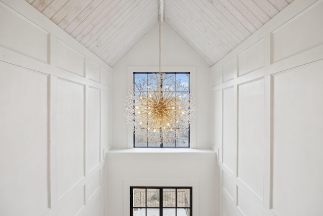 room details with wooden ceiling, a chandelier, and a decorative wall