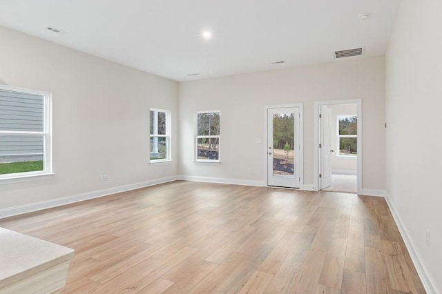 unfurnished room with visible vents, baseboards, and light wood finished floors