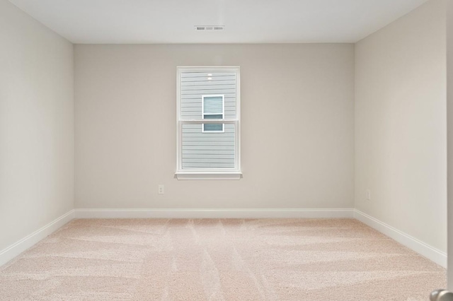 carpeted empty room featuring visible vents and baseboards