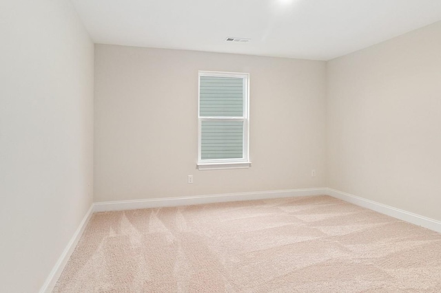 unfurnished room featuring visible vents, carpet flooring, and baseboards