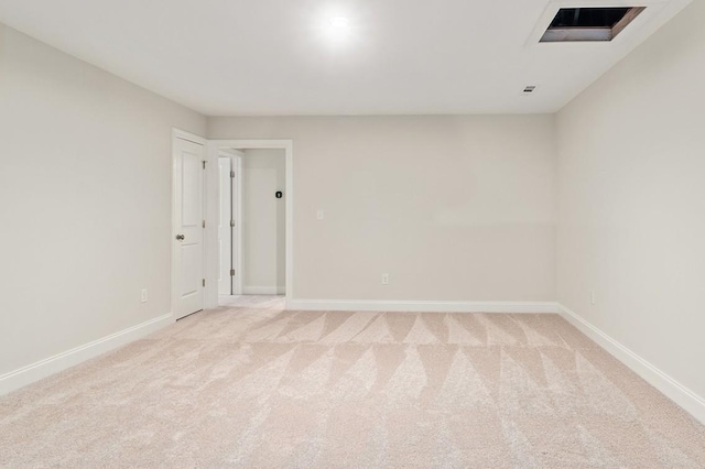 unfurnished room featuring light colored carpet and baseboards