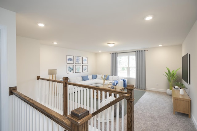 carpeted living area featuring baseboards and recessed lighting