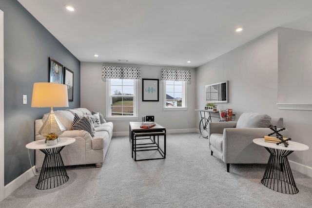 carpeted living area with baseboards and recessed lighting