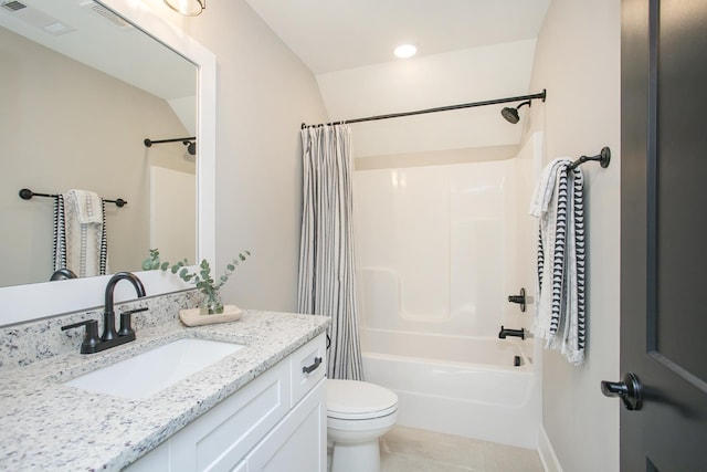 bathroom featuring toilet, vanity, visible vents, tile patterned floors, and shower / bath combo