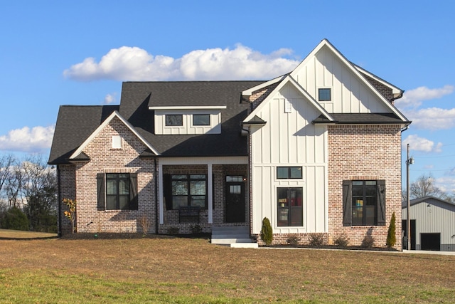 modern farmhouse style home featuring brick siding, a shingled roof, board and batten siding, and a front yard