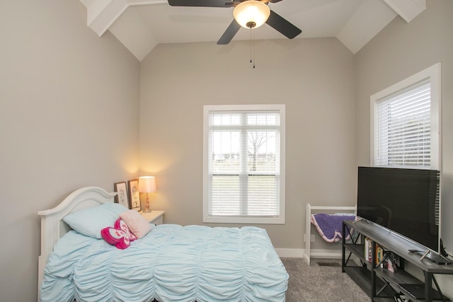 carpeted bedroom with vaulted ceiling, ceiling fan, multiple windows, and baseboards