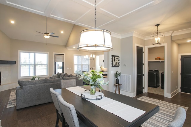 dining space featuring dark wood-style floors, visible vents, vaulted ceiling, a tile fireplace, and baseboards