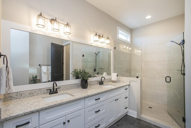 full bath with a stall shower, tile patterned flooring, a sink, and double vanity