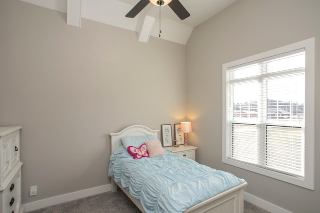 carpeted bedroom featuring lofted ceiling with beams, ceiling fan, and baseboards