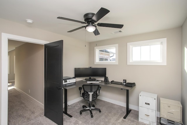 carpeted office with visible vents, ceiling fan, and baseboards