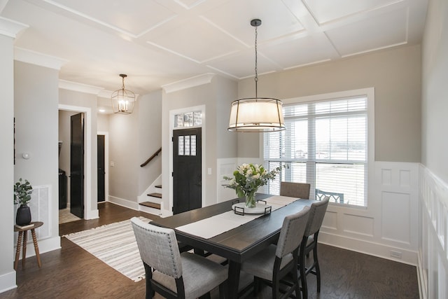 dining space with a wainscoted wall, dark wood-style flooring, coffered ceiling, visible vents, and stairs