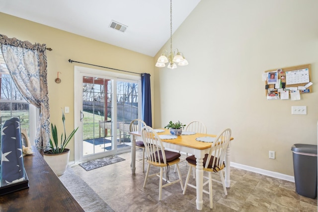 dining area featuring high vaulted ceiling, visible vents, baseboards, and an inviting chandelier