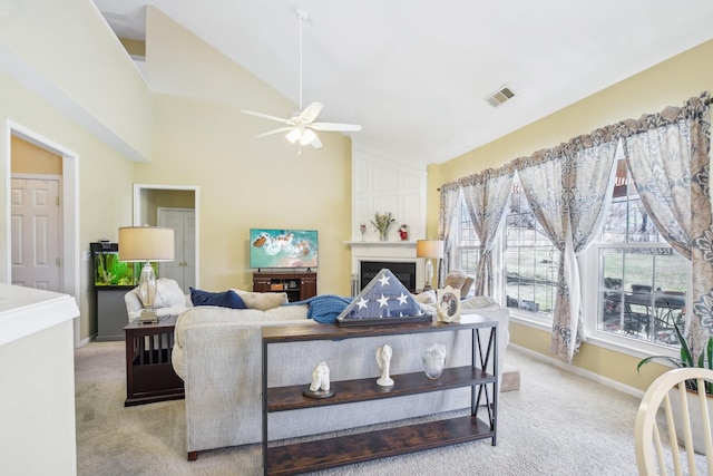 living room featuring light carpet, a fireplace, visible vents, and baseboards