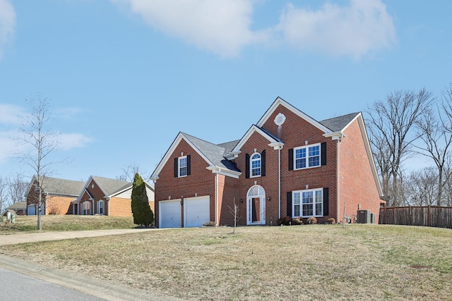 view of front of house featuring cooling unit, a garage, brick siding, fence, and a front yard