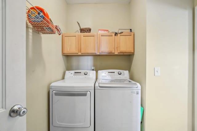 washroom featuring cabinet space and washer and dryer