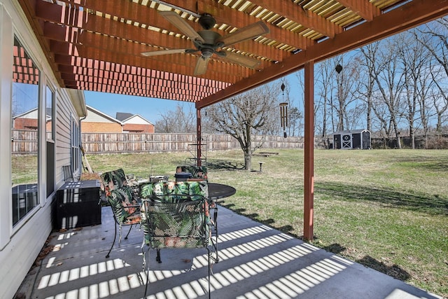 view of patio featuring a storage shed, outdoor dining space, a pergola, a fenced backyard, and an outdoor structure