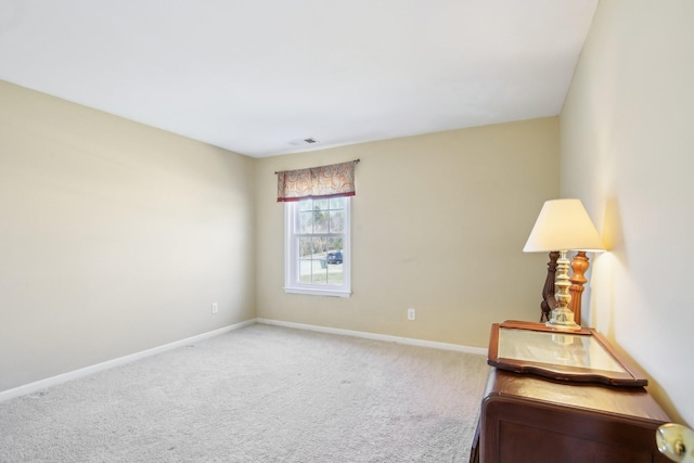 unfurnished room with carpet flooring, visible vents, and baseboards